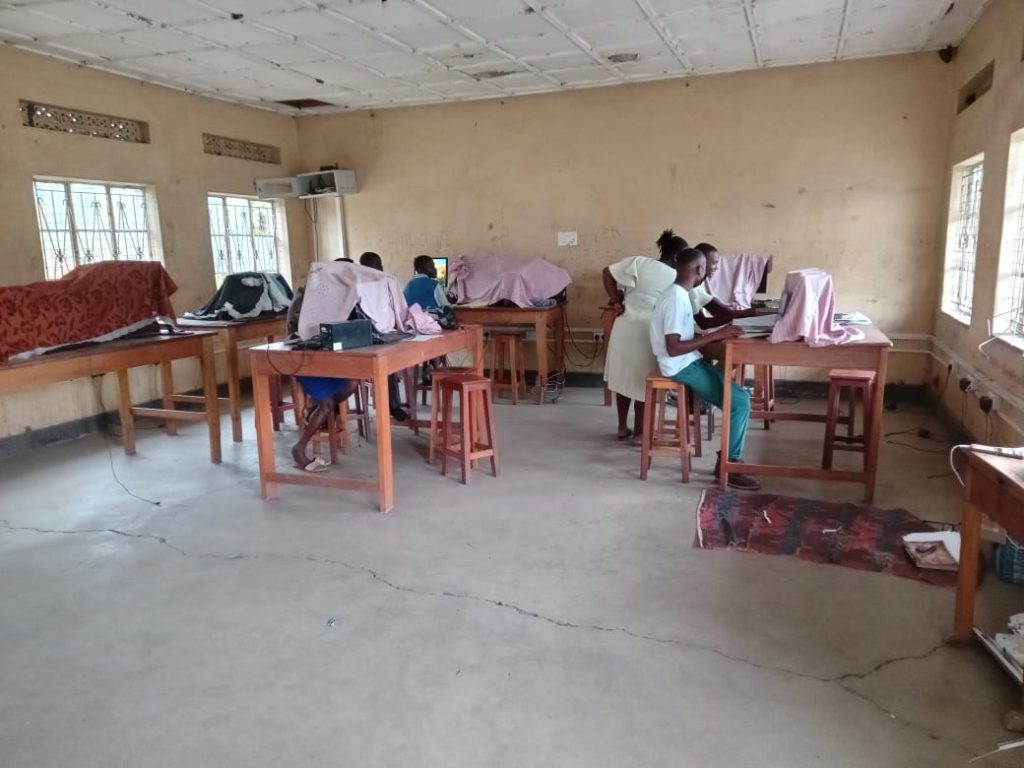 Students participating in a hands-on practical skills training session at Muhokya Parents Secondary School in Kasese.