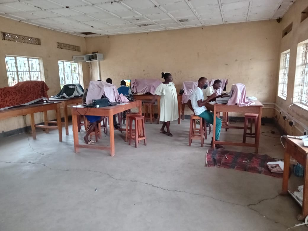 Students participating in a hands-on practical skills training session at Muhokya Parents Secondary School in Kasese.